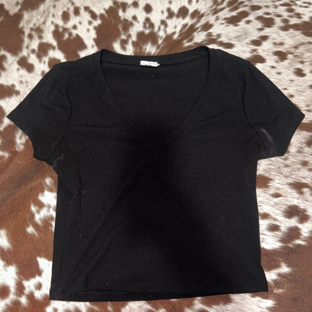 Medium cropped black t-shirt with front design.